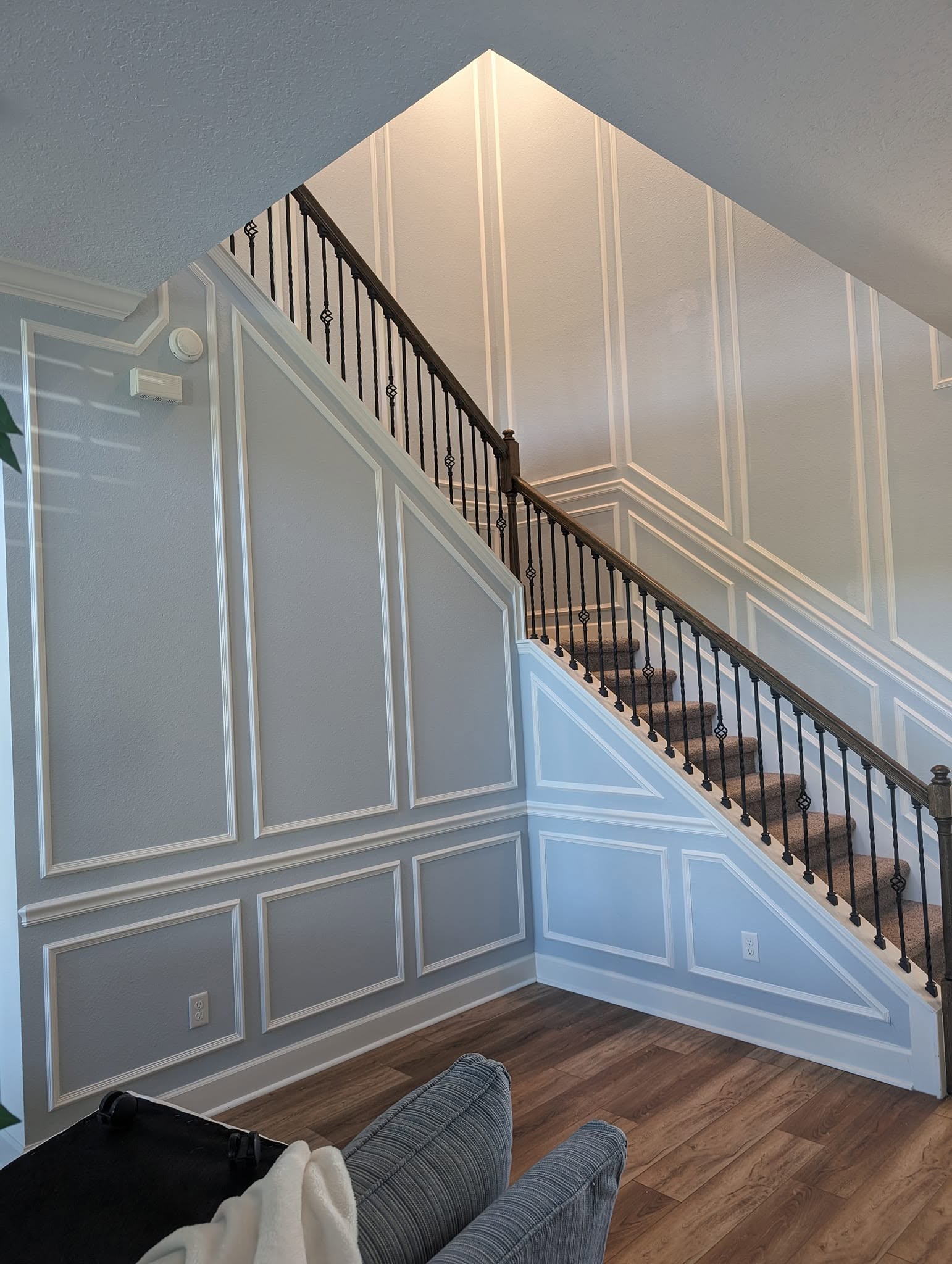 White paneled stair wall with precise decorative molding
